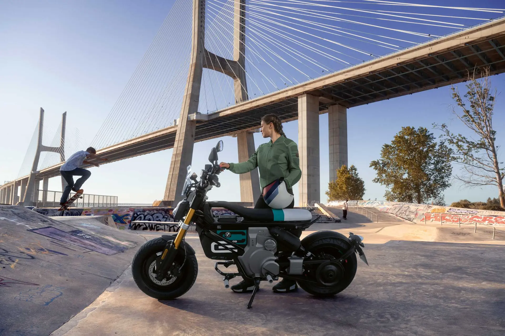 BMW CE 02 parked beside an urban skate park