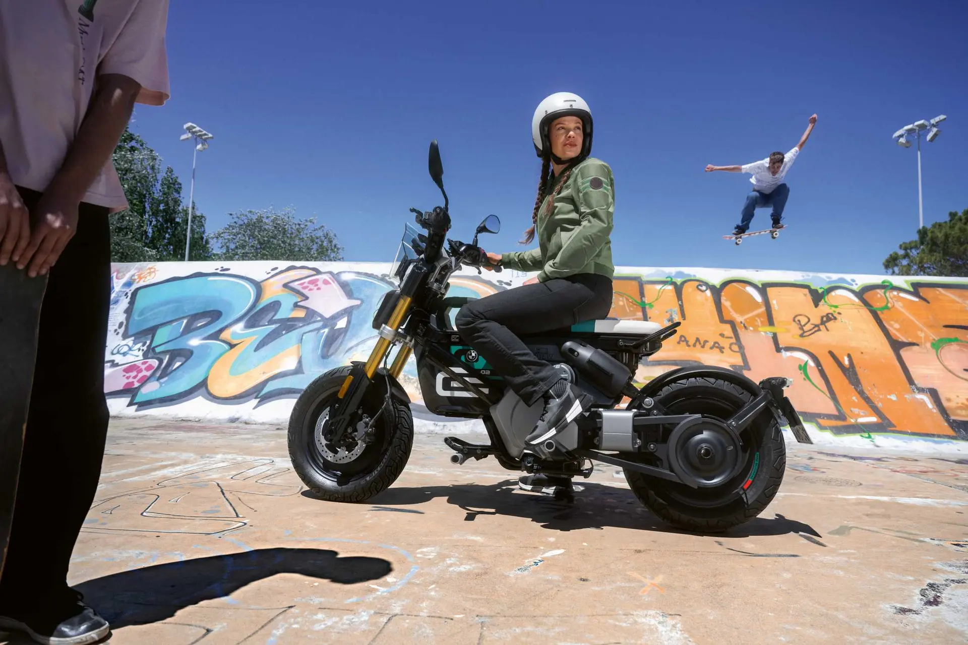 Rider seated on a BMW CE 02 electric city bike