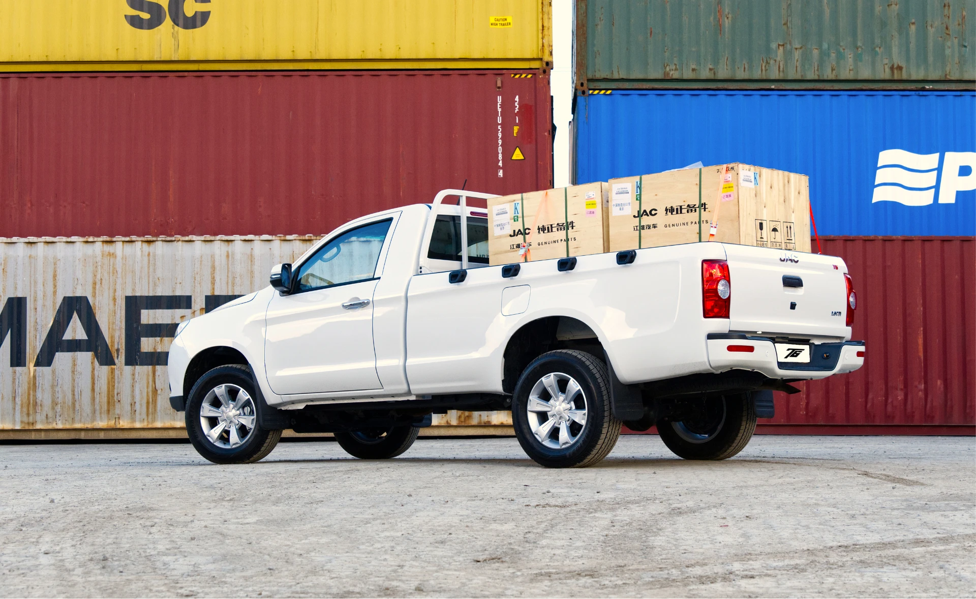 White JAC T6 Single Cab carrying boxed cargo at a container yard