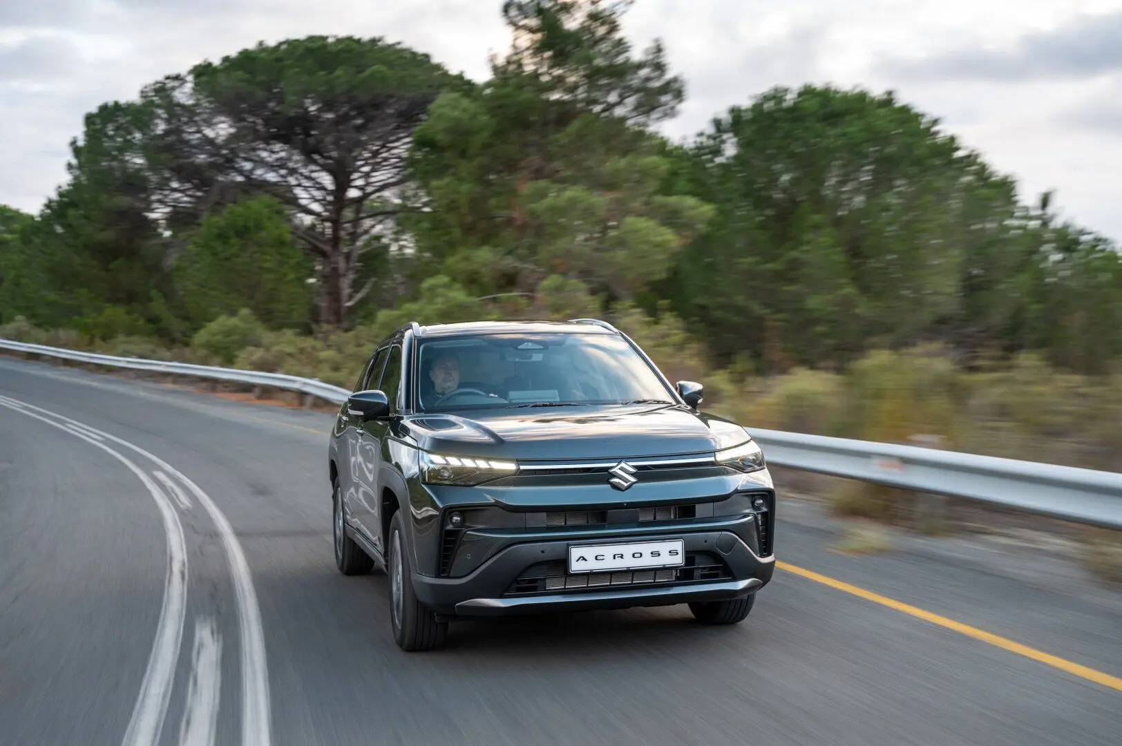 Dark green Suzuki Across driving on a South African road